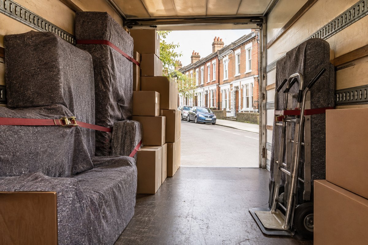 Inside a loaded removal van in Coventry, blanket-wrapped furniture and boxes
